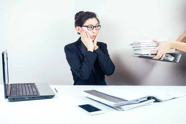 attractive smart brunette woman business lady in stylish business suit and glasses working with laptop and screams in panic in office . business concept and deadline