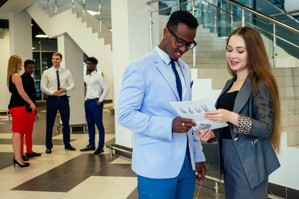 Portrait of ambitious business team diverse ethnicity multinational people in stylish suit getting communicating together in lobby of modern the office . — Stock Photo, Image