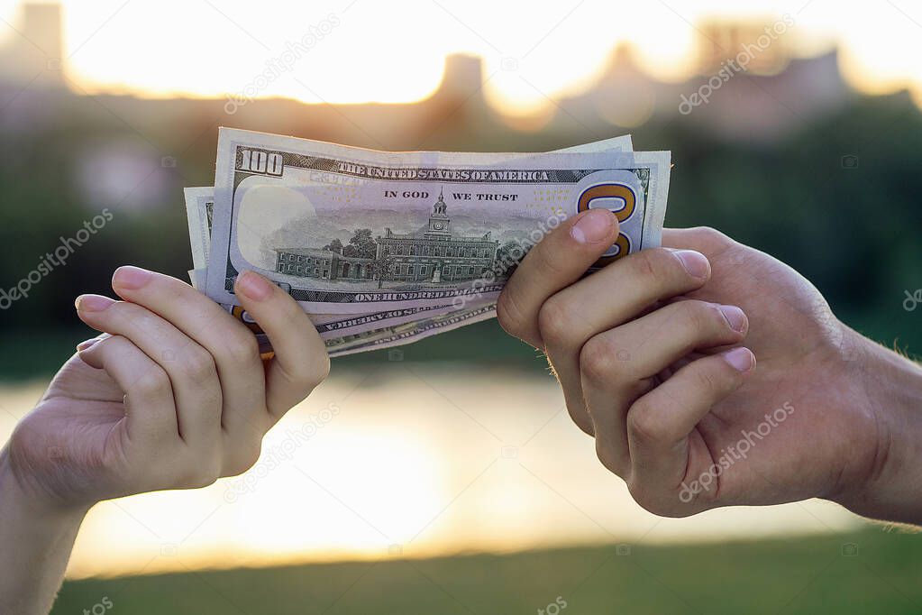 big bill of dollars in white hands