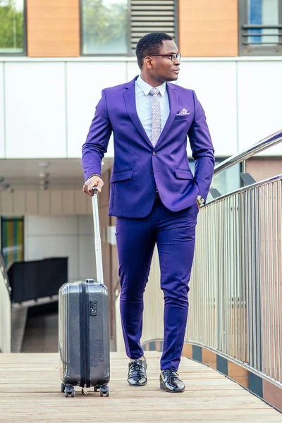 Afro american man well dressed and successful african businessman walking train at railway station bus station. a trip to a business meeting in the capital to business partners