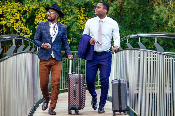 two african american business partners go towards the airport for a business meeting international Conference