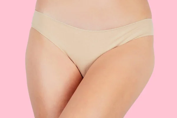 Anti-cellulite massage.Woman in beige panties massaging thigh massage receiving a professional anti cellulite cans jars, banks ventuza vacuum leg hips and butt ass on a pink background in the studio — Stock Photo, Image