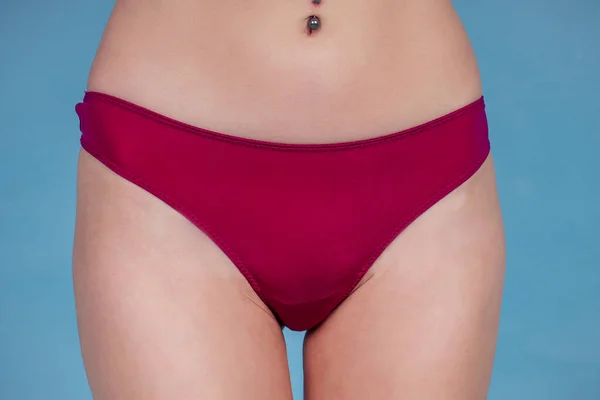 Red women panties on a blue background — Stock Photo, Image