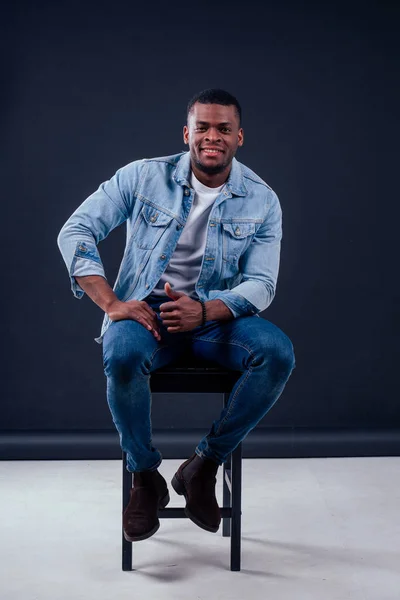 African American healthy male model in a cotton white t-shirt woth Jean jacket in studio summer lifestyle