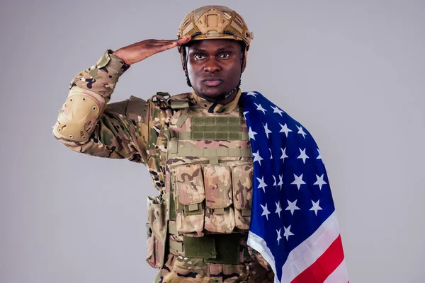 African american soldier with folded arms standing in white studio