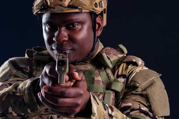 military army african male warrior camouflage suit sorrow sadness wrapped in an American flag black background studio, lying violence news criminal media