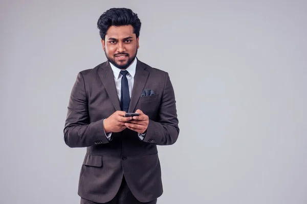 Success handsome Arabian businessman classic suit talking by phone in white studio background — Stock fotografie