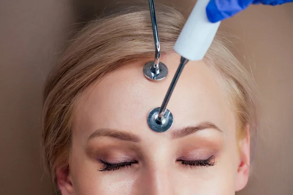 Beauty aesthetic spa salon .blonde female getting instrument facial massaging with microcurrent electro instrument device. — Stock Photo, Image