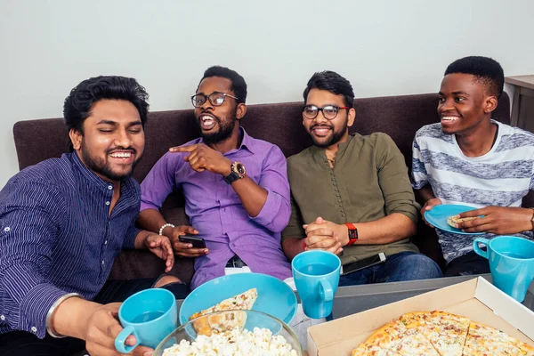 Happy african american friends eating pizza at home Stock Photo by  Prostock-studio