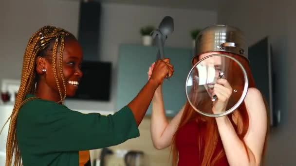 Mixed race couple struggling with a saucepan on my head kitchen — Stock Video