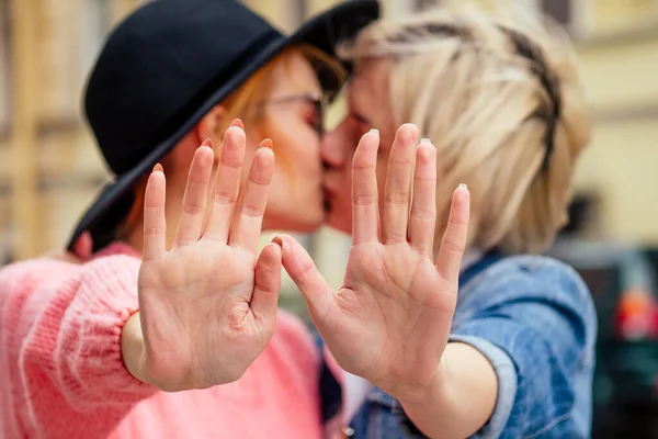 Redhaired young ginger woman feeling love to her blonde girlfriend in Europe streets shoving stop hands gesture — Stock Photo, Image