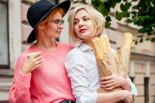 Happy women using social network app meeting website outdoors in Europe — Photo