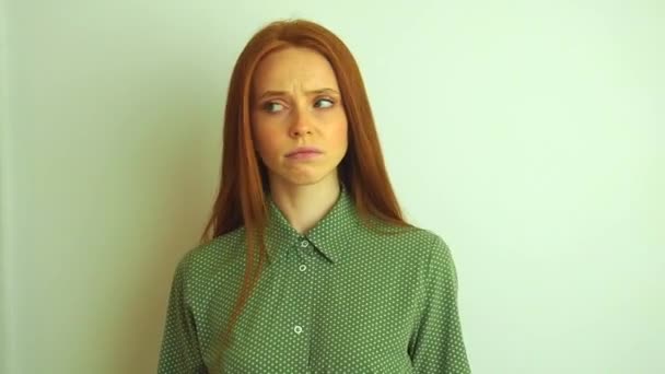 Kvinna kliar huvudet i tanken på en vit bakgrund — Stockvideo