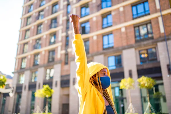 Mulher latino-brasileira de capuz amarelo com tranças amarelas dreadlocks na rua tomou para o parque público e ruas para protestar feminismo — Fotografia de Stock