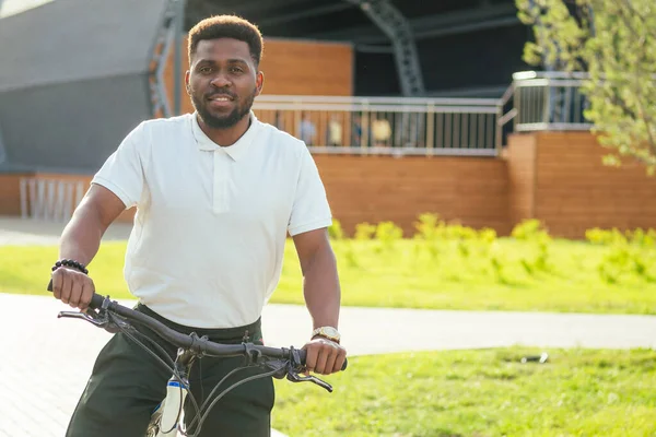 ecology and transportation concept. modern young Afro American businessman cycling to work on bicycle