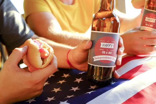4th of July celebration party, young men hands holding beer bottle, holiday label design, Happy Independence day, hot dog, mustard, catchup. American flag, river recreation area. Close up, background