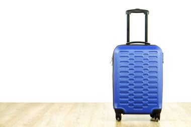 Genişletilmiş Teleskopik Saplı Tek mavi plastik sert kabuklu Bagaj. İş gezisi için hazırlanmış bir bavul. Yalnız kavramı seyahat. Beyaz dokulu duvar arka plan, metin için kopya yer yakın çekim.