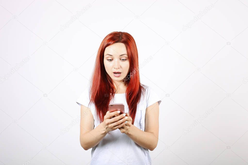 Obsessed crazy teenager girl with the mobile phone technology isolated on a white background