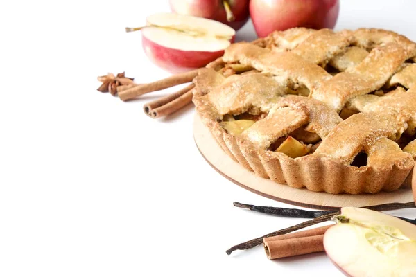 Traditional American Thanks Giving pie, whole & halved apples, cinnamon sticks, anise seeds. Homemade fruit tart baked to golden crust with ingredients. Close up, copy space, top view, background.