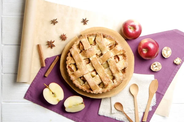 Traditional American Thanks Giving pie, whole & halved apples, cinnamon sticks, anise seeds. Homemade fruit tart baked to golden crust with ingredients. Close up, copy space, top view, background.