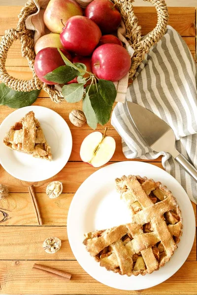 Traditional American Thanks Giving pie, whole & halved apples, cinnamon sticks, anise seeds. Homemade fruit tart baked to golden crust with ingredients. Close up, copy space, top view, background.