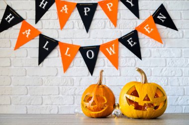 Farklı büyüklükte birkaç Turuncu kabak Jack o fener ahşap masa üzerinde oyulmuş. Arka plan, uzay kopyalayın, yakın çekim, görünümü top. Tüm eve Cadılar Bayramı partisi dekorasyon toplantı salonu. Ya parani ya canini kavramı.