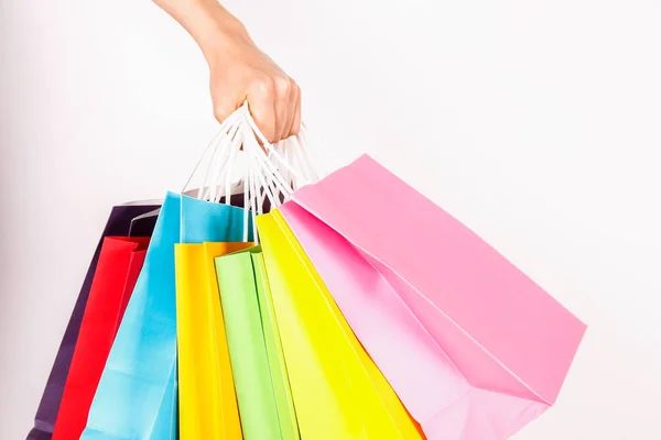 Foto Recortada Mano Femenina Sosteniendo Racimo Diferentes Bolsas Compras Blanco —  Fotos de Stock