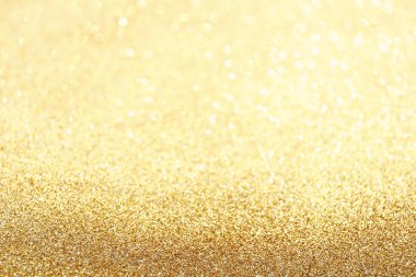 Altın ışıltı bokeh etkisi ve selectieve odak ile parlıyor. Festival arka plan parlak altın ışıklar, şampanya kabarcık ile. Noel ruh kavramı. Kopya alanı, yakın çekim, doku, üstten görünüm.