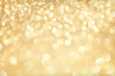Altın ışıltı bokeh etkisi ve selectieve odak ile parlıyor. Festival arka plan parlak altın ışıklar, şampanya kabarcık ile. Noel ruh kavramı. Kopya alanı, yakın çekim, doku, üstten görünüm.