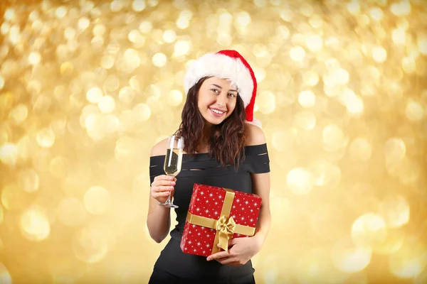黒のタイトなセクシーなドレス サンタ クロース帽子飲むシャンパンを着てクリスマスを祝う若いの魅力的な女性の肖像画 お祭りの背景 コピー領域をクローズ アップ クリスマス気分のコンセプト — ストック写真