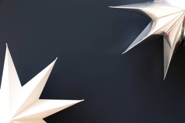 Kopya alanı metin için bir sürü renkli arka plan üzerinde beyaz kağıt yıldız ile minimalist kompozisyon. Üstten görünüm, düz yatıyordu, portre. Noel ruhu kavramı ile pırıltı yıldız.