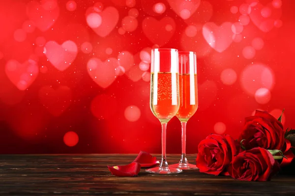 Kırmızı kalp üzerinde iki şampanya flüt gözlüklü kavramsal görüntü bokeh ışıklar şeklinde. Romantik akşam yemeği st Sevgililer günü için. Yakın çekim, alanı Kopyala. Farklı romantik günler için renkli arka plan