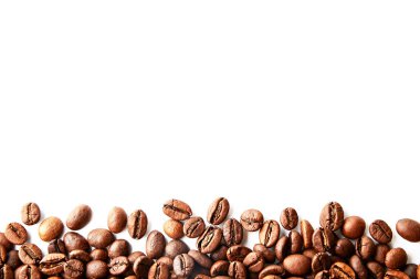 Metin için bir sürü yer Kopyala ile beyaz tabloda kavrulmuş kahverengi kahve çekirdekleri dağınık. Düz yatıyordu kompozisyon. Yakın çekim, görünümü, arka plan top.