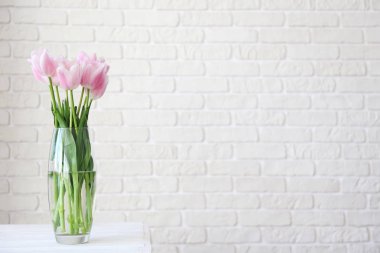 Masada cam vazo çiçeklerile Yüce iç.