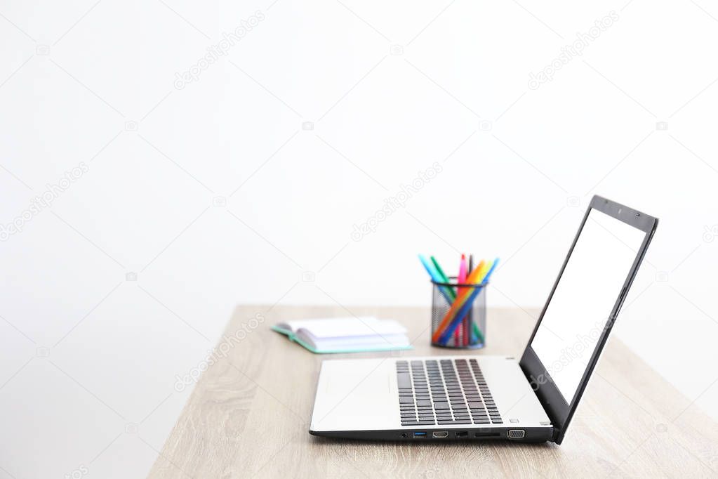 Minimalistic composition of workplace with laptop and stationery.