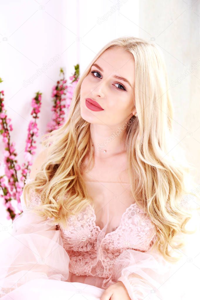 Bridal makeup concept. Gorgeous young woman with long blonde hair.