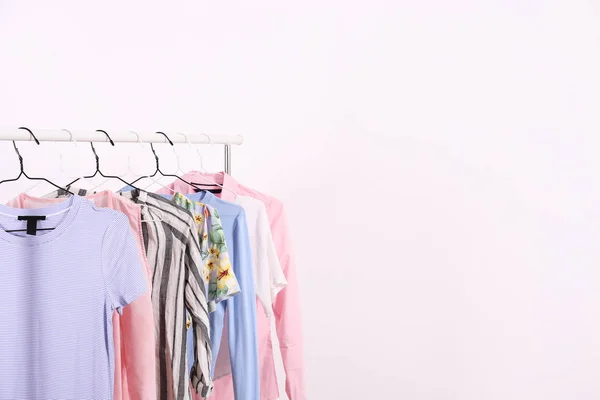 Different colorful casual clothing hanging in row. — Stock Photo, Image