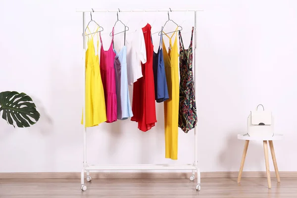 Different colorful casual clothing hanging in row. — Stock Photo, Image