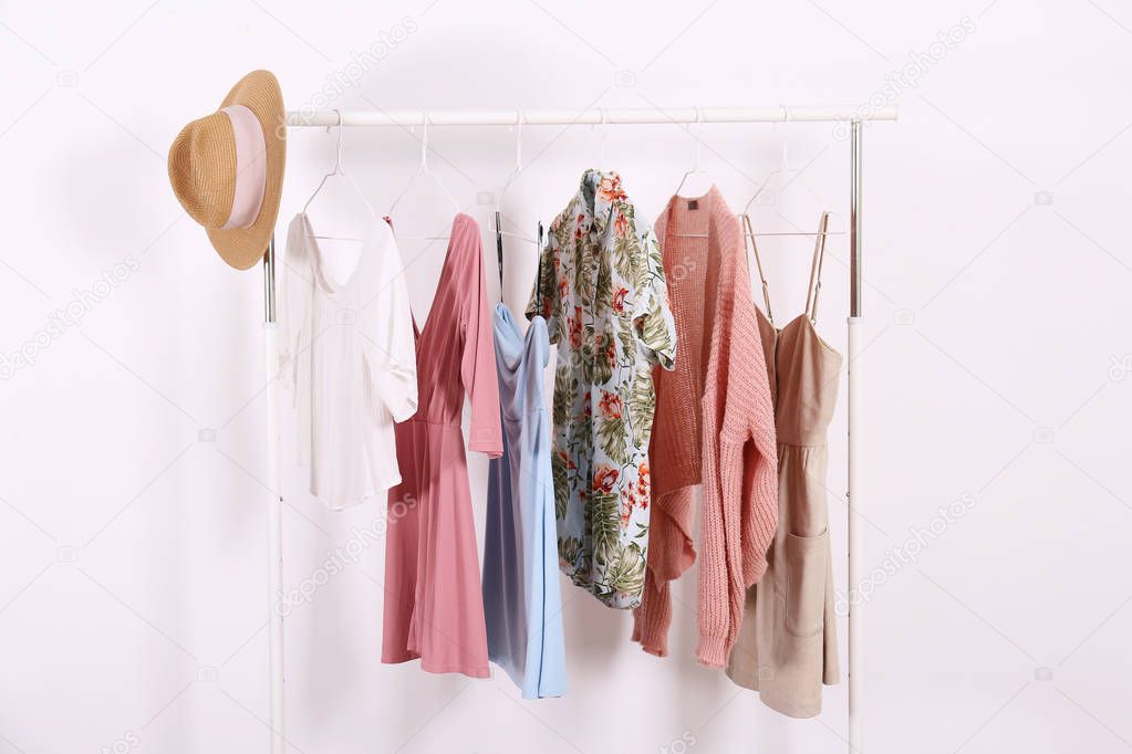 Different colorful casual clothing hanging in row.