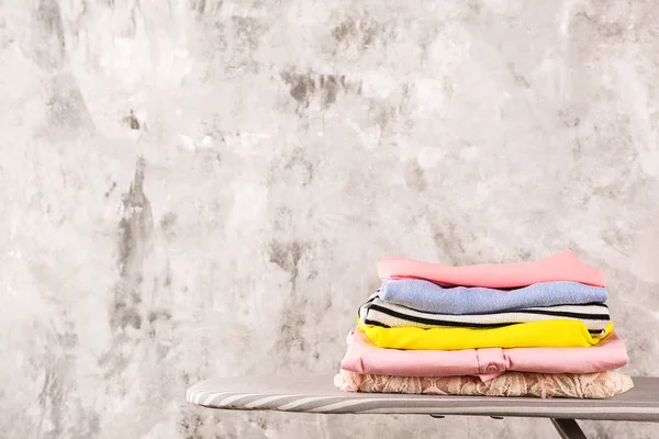 Bunch of different colorful clothing items folded in stack.