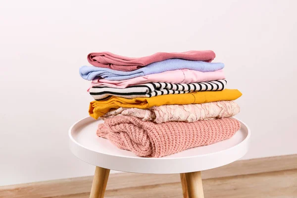 Bunch of different colorful clothing items folded in stack.