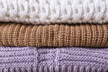 Mükemmel yığılmış farklı renk ve desenler örme kazak yığını.