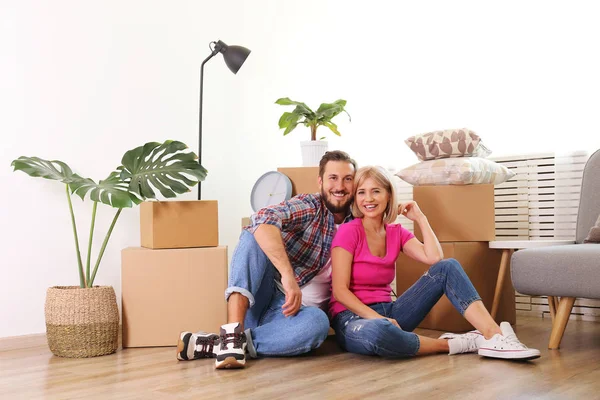 Joven pareja casada mudándose en nuevo apartamento, sentado en el flo — Foto de Stock