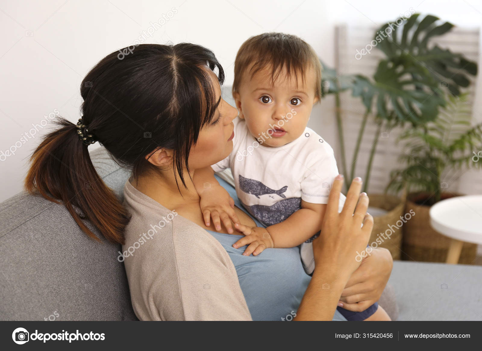 Portrait of young mother taking care of her little son at home. Beautiful female with straight brunette hair playing with child at living room. Close up, copy space, background. Stock Photo by © Portrait of young mother taking care of her little son at home. Beautiful female with straight brunette hair playing with child at living room. Close up, copy space, background. Stock Photo by ©