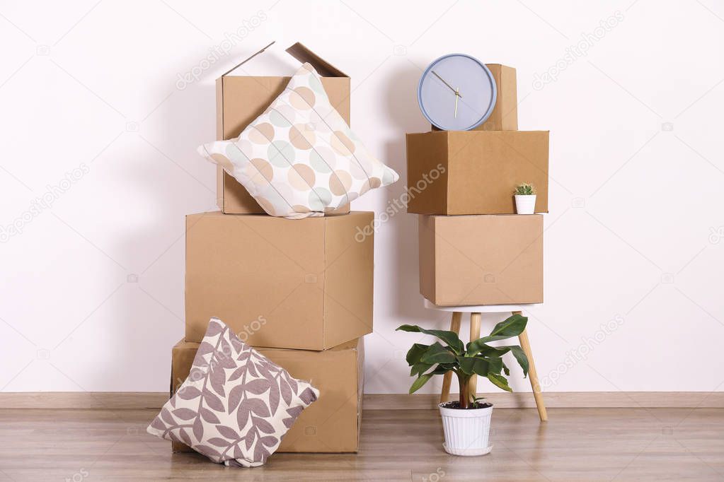 Starting a new life concept. Stacked boxes in minimalistic interior of a new apartment.