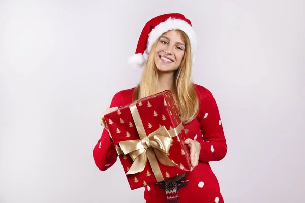 Beautiful smiling young woman wearing knitted sweater celebrating Christmas. Attractive blonde female, new years eve. Ugly Christmas sweater concept. Copy space background, close up portrait, isolated — Stock Photo, Image