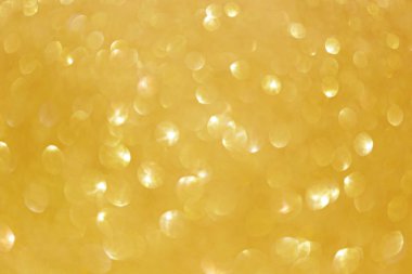 Altın ışıltı bokeh etkisi ve selectieve odak ile parlıyor. Festival arka plan parlak altın ışıklar, şampanya kabarcık ile. Noel ruh kavramı. Kopya alanı, yakın çekim, doku, üstten görünüm.