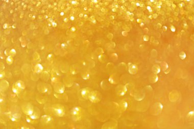 Altın ışıltı bokeh etkisi ve selectieve odak ile parlıyor. Festival arka plan parlak altın ışıklar, şampanya kabarcık ile. Noel ruh kavramı. Kopya alanı, yakın çekim, doku, üstten görünüm.