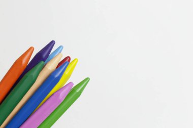 Renkli renkli renkli kalemlerden oluşan bir demet kompozisyonda, beyaza izole edilmiş. Yığınla çizim için yumuşak pastel. Kapat, boşluğu kopyala, üst görünüm.