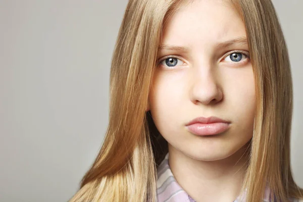 Trendy beauty teenager Close Up Portrait Of Beautiful Teenager Girl With Sad Depressed Facial Expression Pretty Young Woman Long Blonde Hair Looking Stressed And Worried Isolated Background Copy Space Disappointed Studio Stock